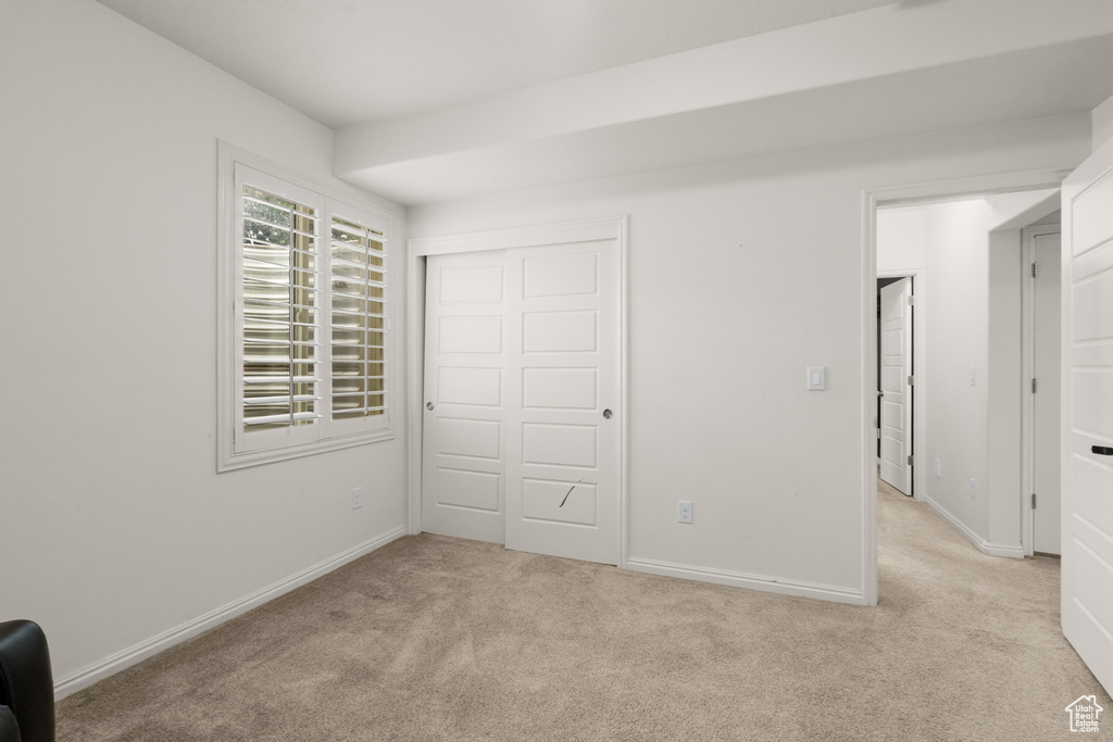 Unfurnished bedroom featuring carpet floors and a closet