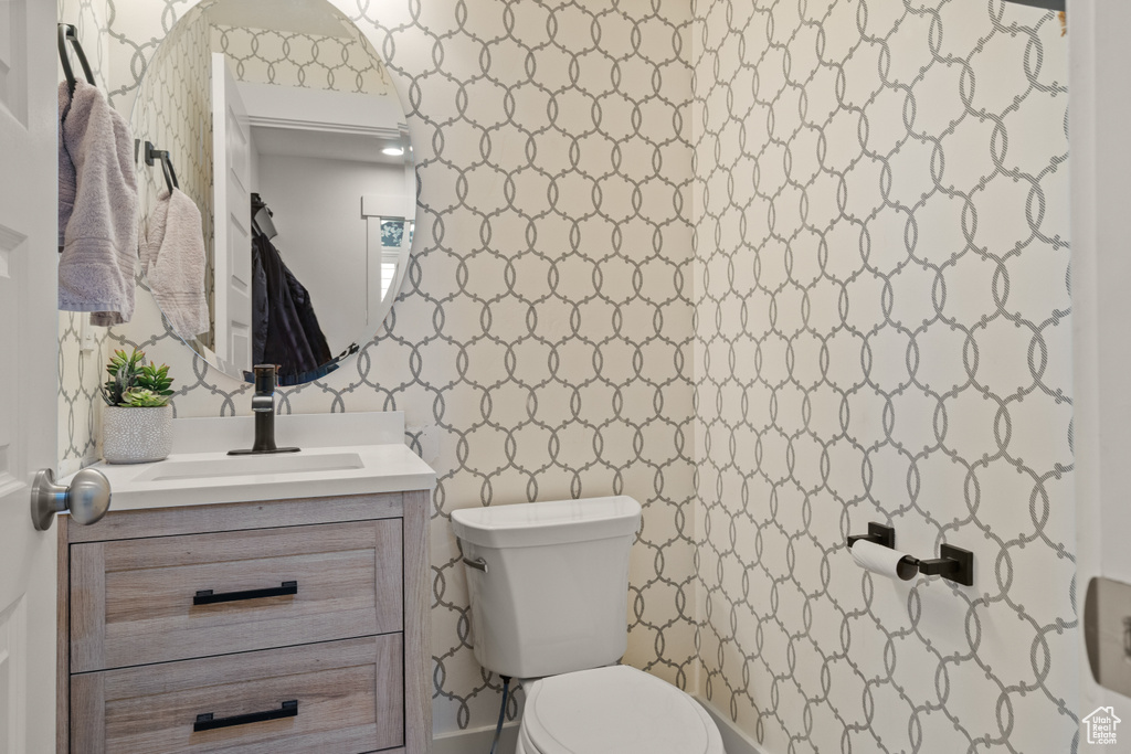 Half bathroom featuring toilet and vanity