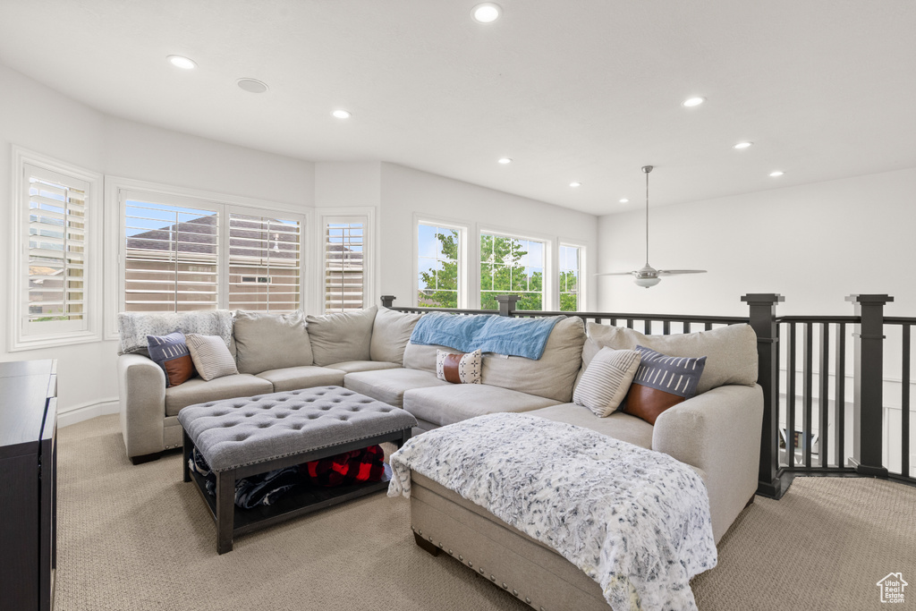 Living area with light colored carpet, recessed lighting, and a ceiling fan