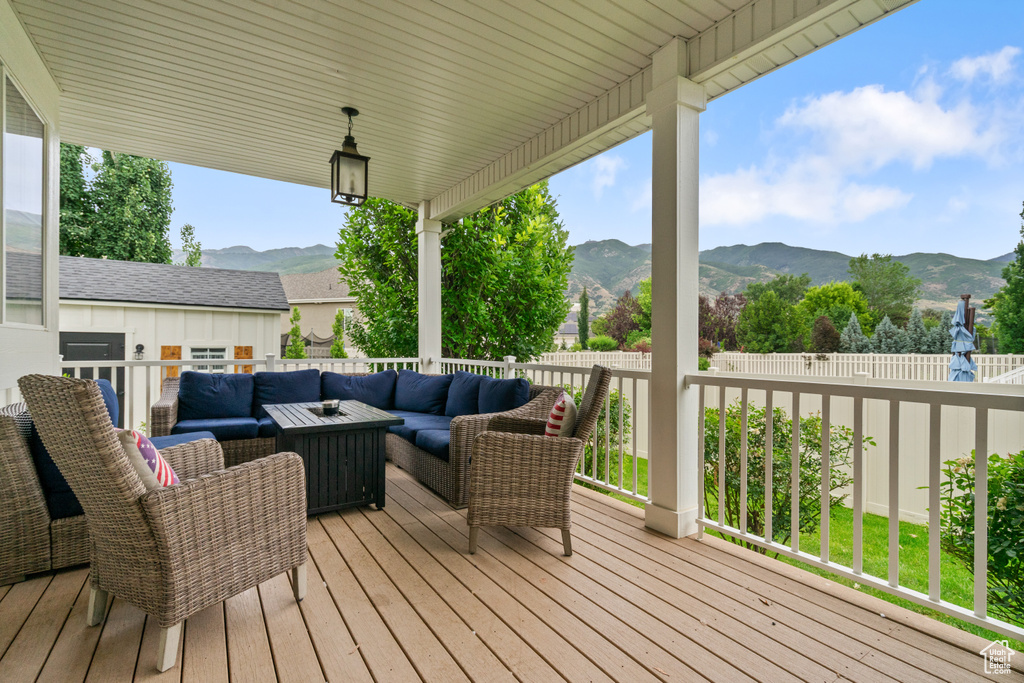 Wooden terrace with an outdoor living space and a mountain view