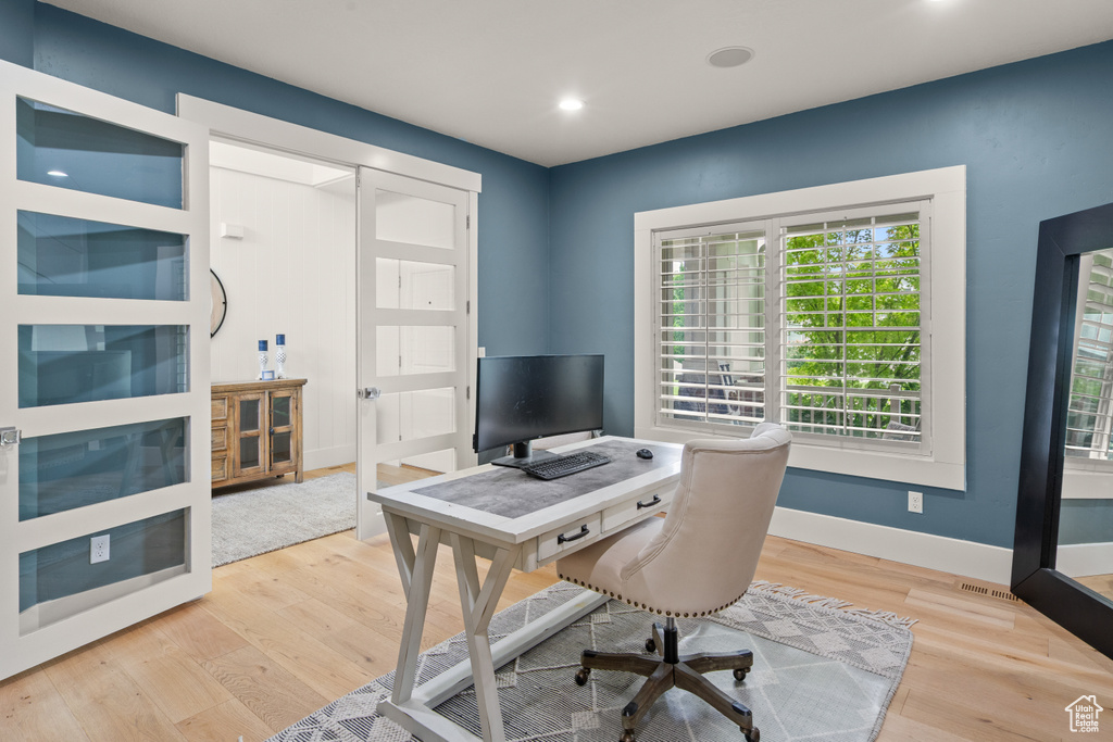 Office area with wood finished floors and recessed lighting
