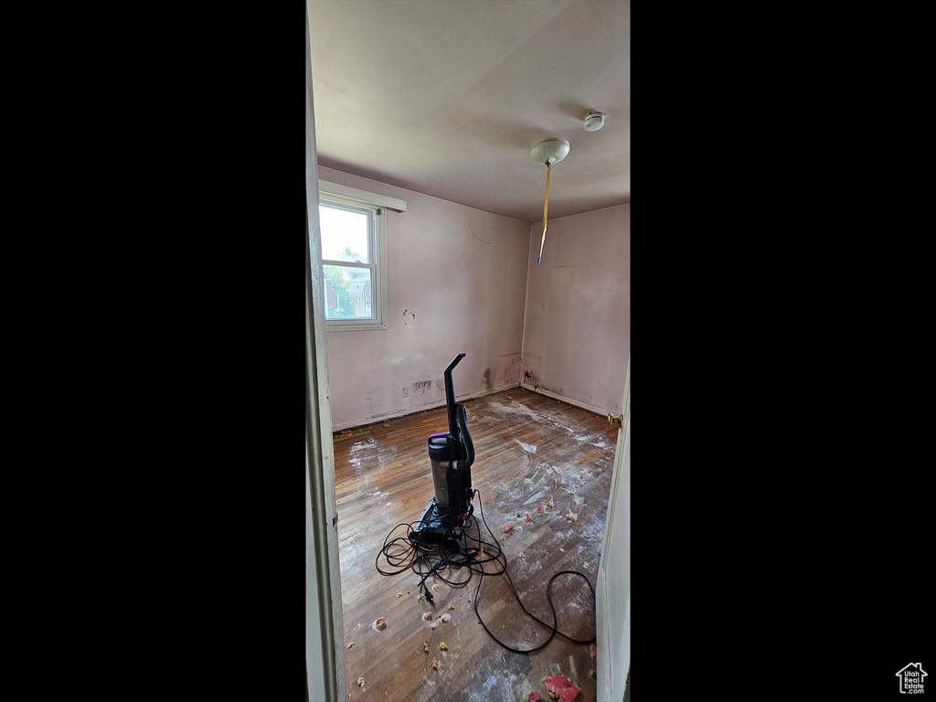 Spare room with hardwood / wood-style flooring and a smoke detector