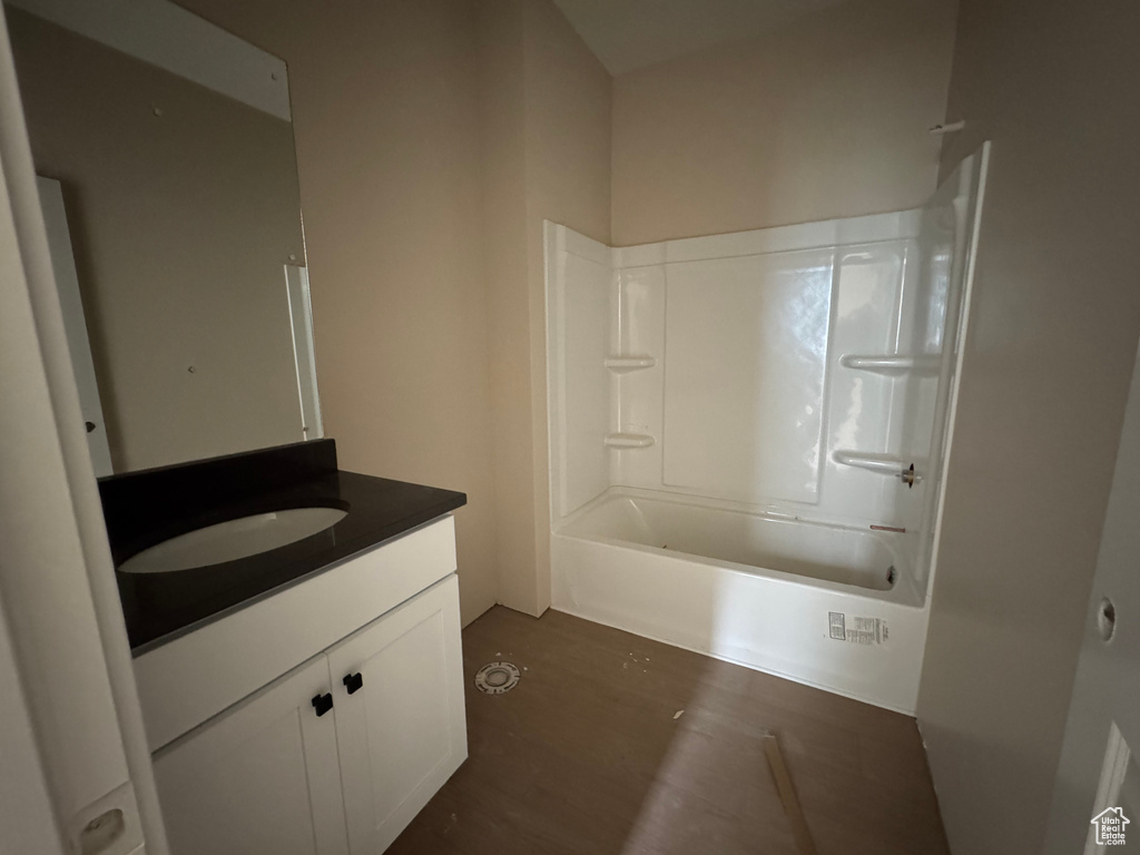 Bathroom with vanity, shower / bathtub combination, and wood finished floors