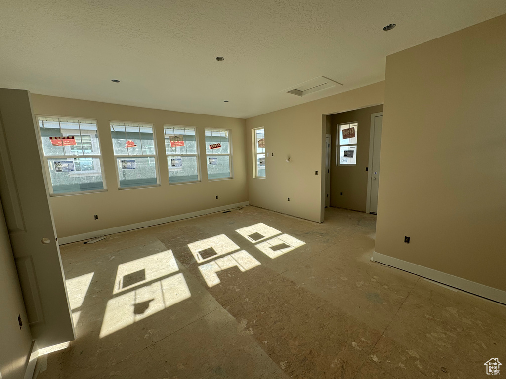Unfurnished room featuring a textured ceiling