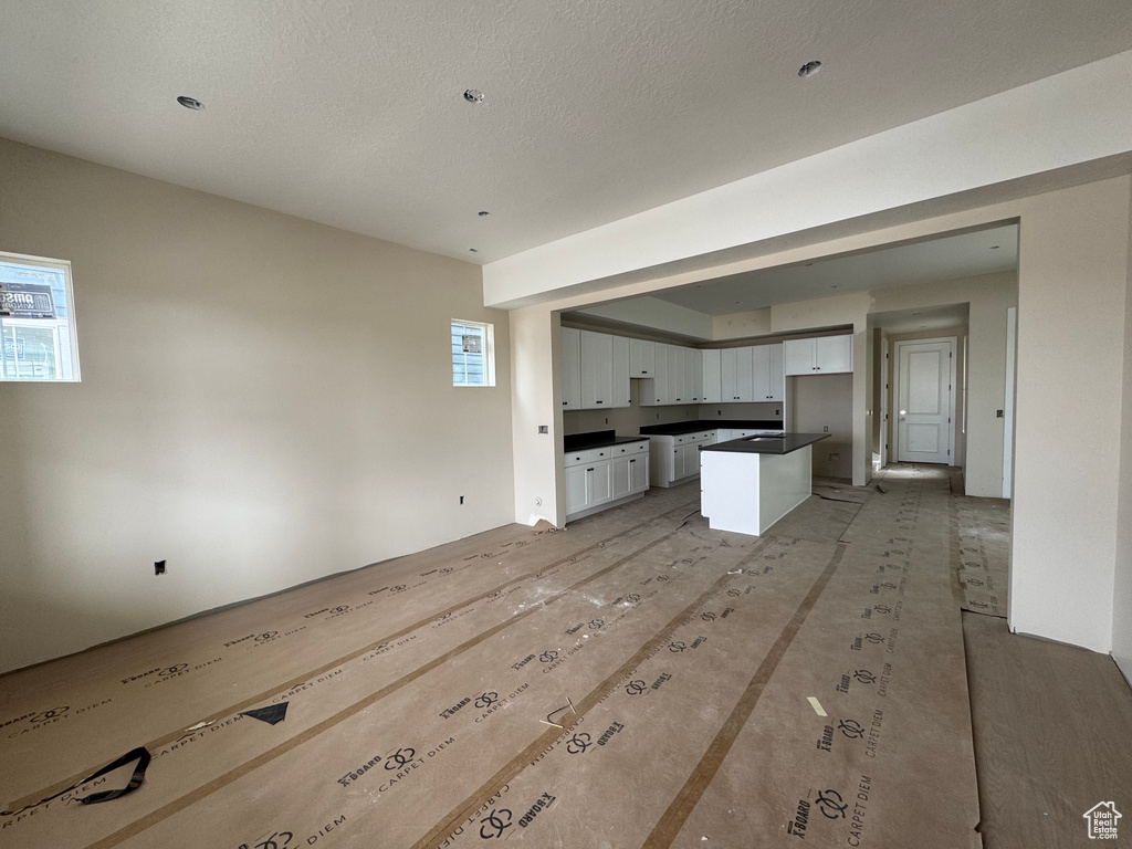 Unfurnished living room featuring plenty of natural light