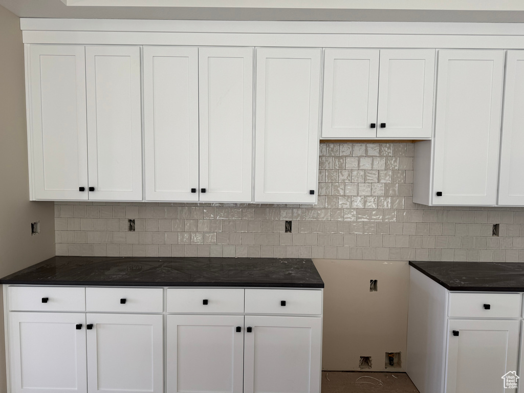Kitchen with white cabinets and decorative backsplash