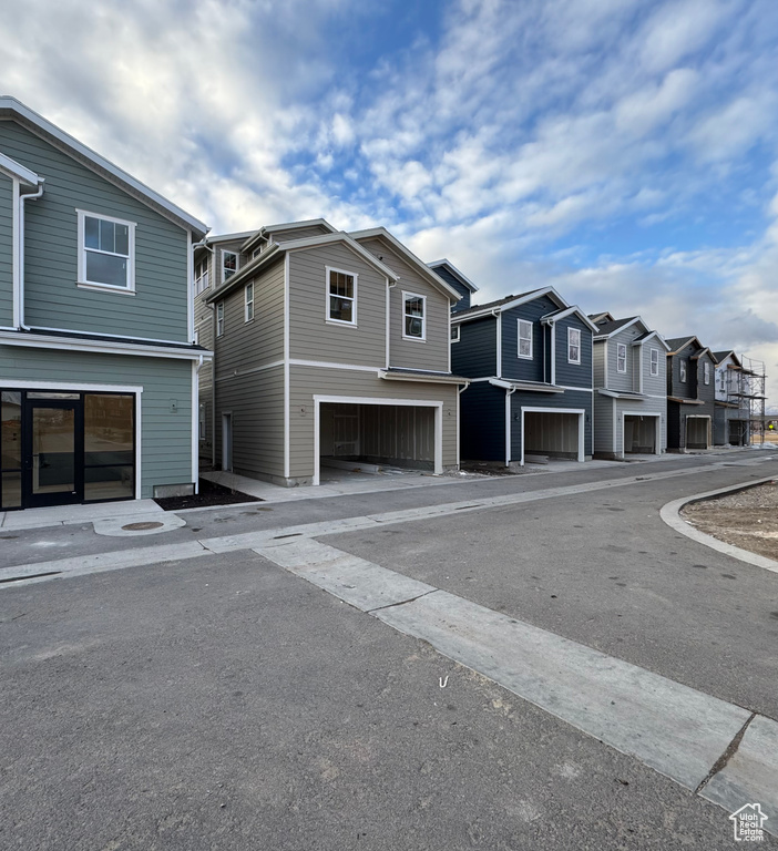 View of asphalt street featuring a residential view