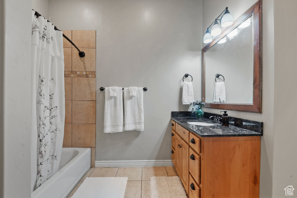 Bathroom with tile patterned flooring, vanity, and shower / bath combination with curtain