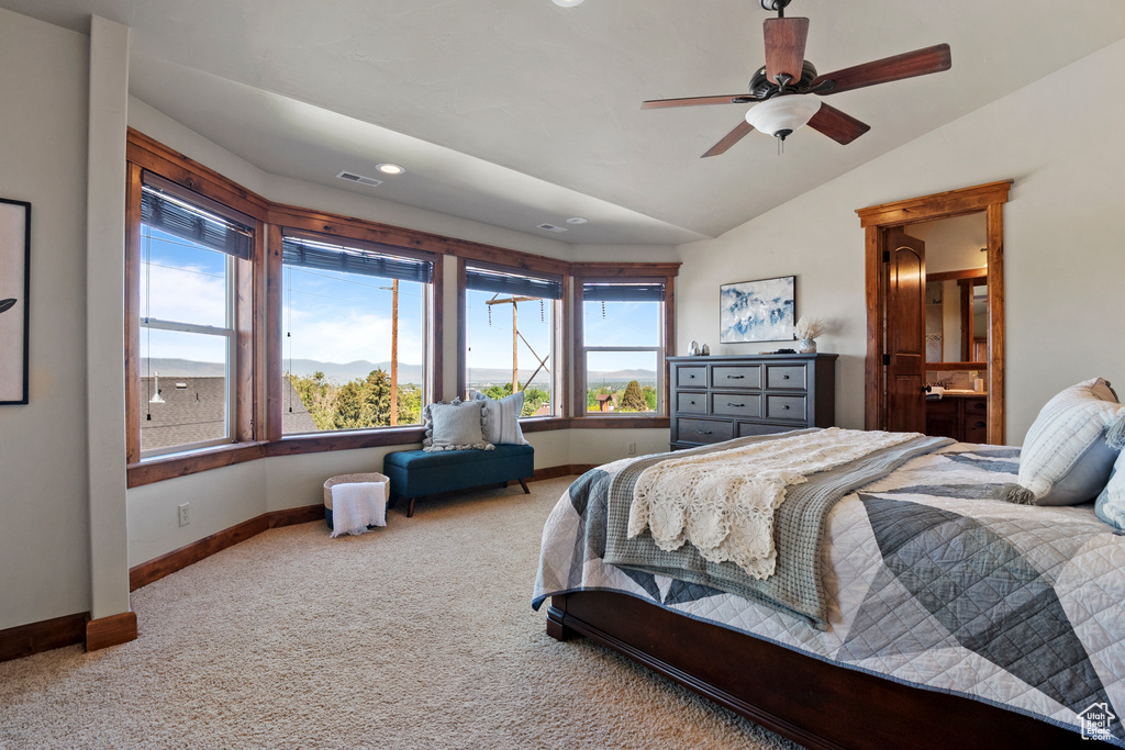 Bedroom featuring carpet flooring, lofted ceiling, recessed lighting, and ensuite bath