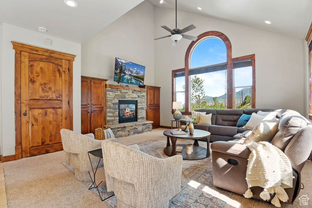 Living area with recessed lighting, high vaulted ceiling, a fireplace, and a ceiling fan