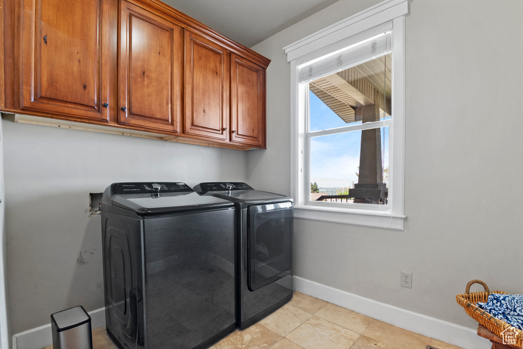 Laundry room with separate washer and dryer and cabinet space
