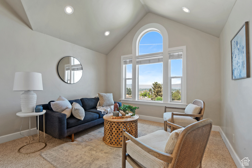 Living area with light colored carpet, lofted ceiling, and recessed lighting