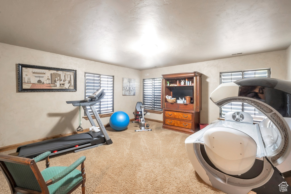 Workout room with carpet and baseboards