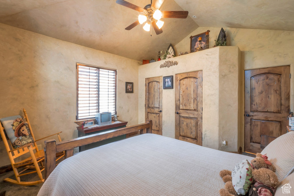 Bedroom featuring vaulted ceiling and a ceiling fan