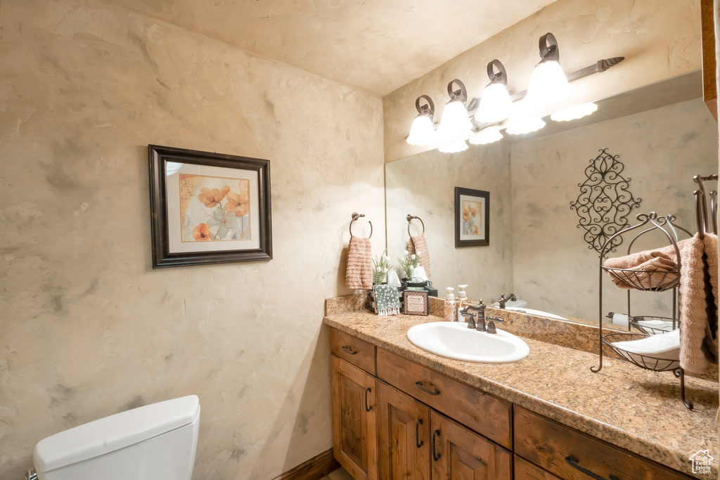 Half bath with vanity and toilet