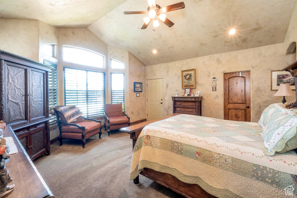 Bedroom featuring carpet floors, high vaulted ceiling, and a ceiling fan