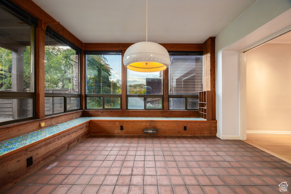 Unfurnished sunroom featuring tile patterned floors