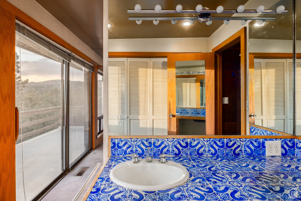 Bathroom with a closet and vanity