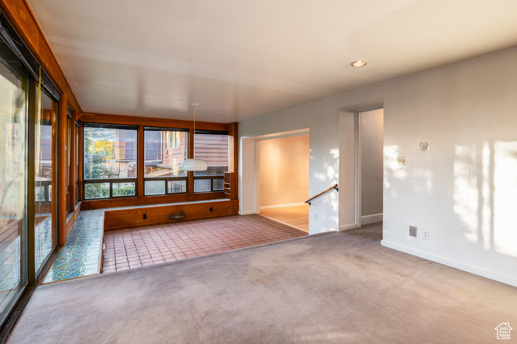 Unfurnished sunroom with carpet flooring and recessed lighting