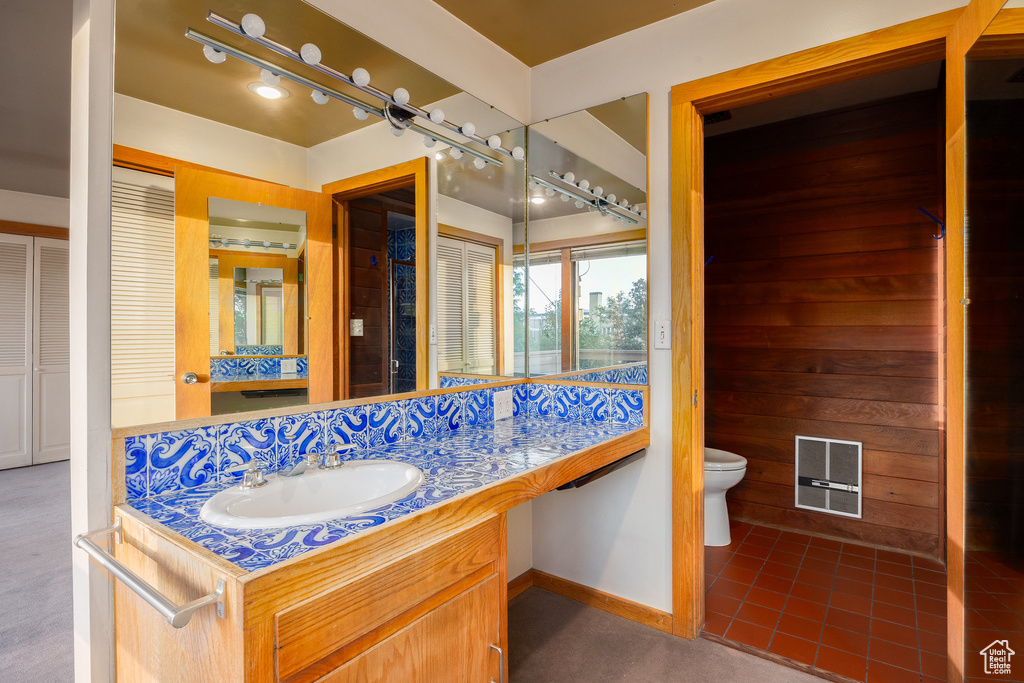 Ensuite bathroom featuring toilet and vanity