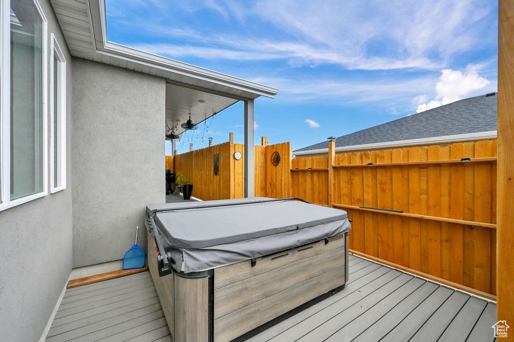 Wooden deck featuring a hot tub