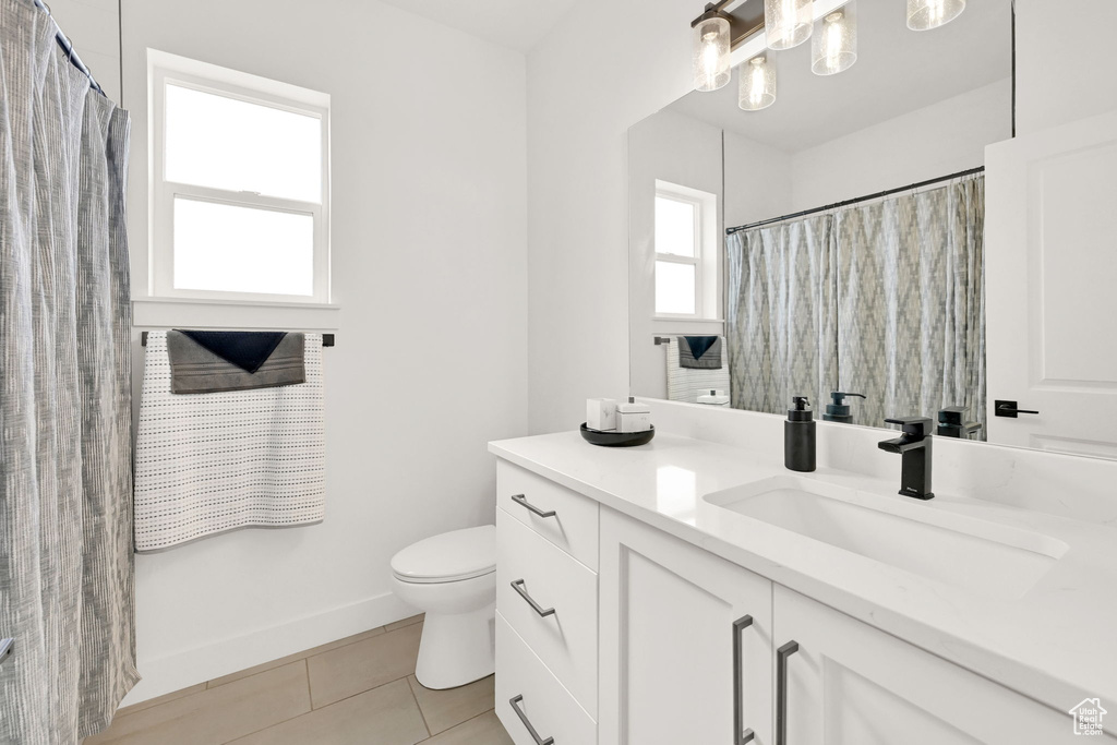 Full bath featuring vanity and tile patterned flooring