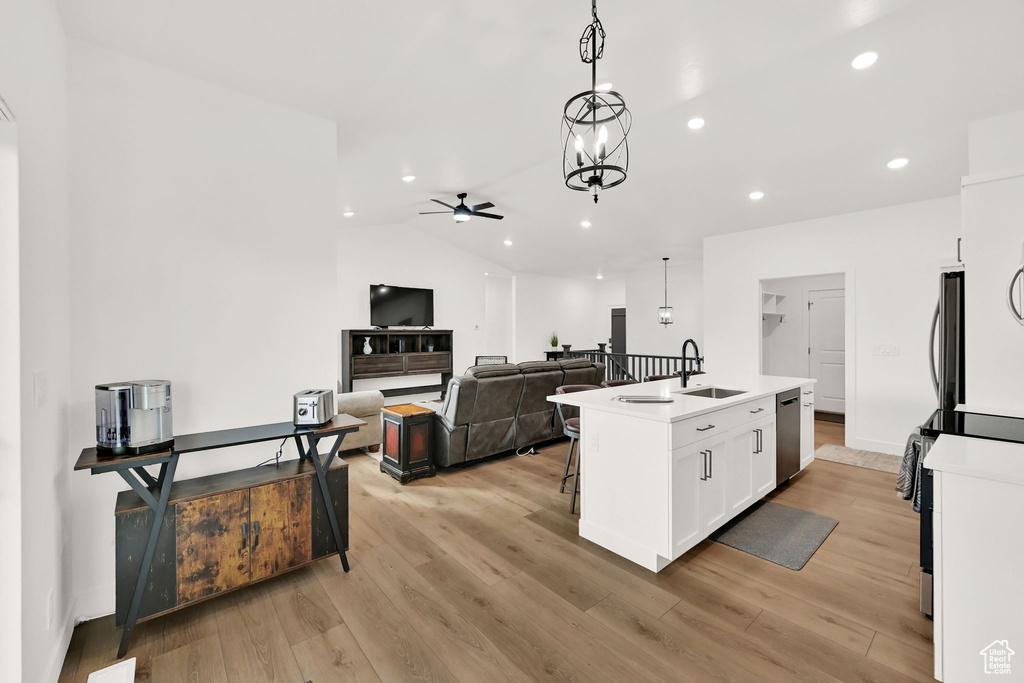 Kitchen featuring stainless steel appliances, a ceiling fan, recessed lighting, white cabinets, and light wood-style flooring