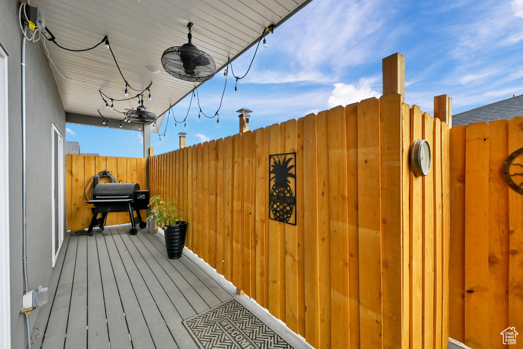 Wooden terrace featuring a grill