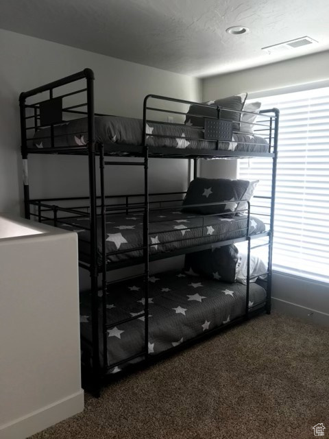 Unfurnished bedroom with carpet and baseboards