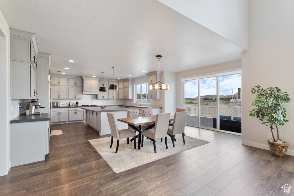 Dining space featuring recessed lighting and dark wood-type flooring
