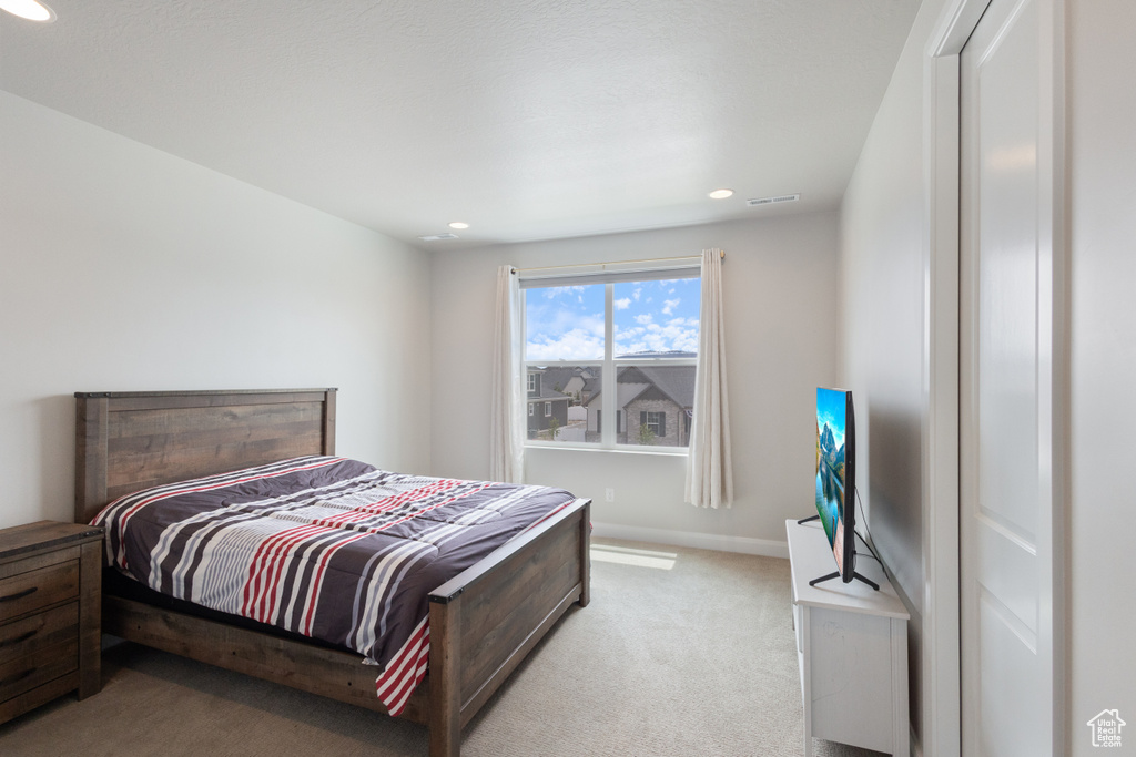 Bedroom featuring light carpet and recessed lighting