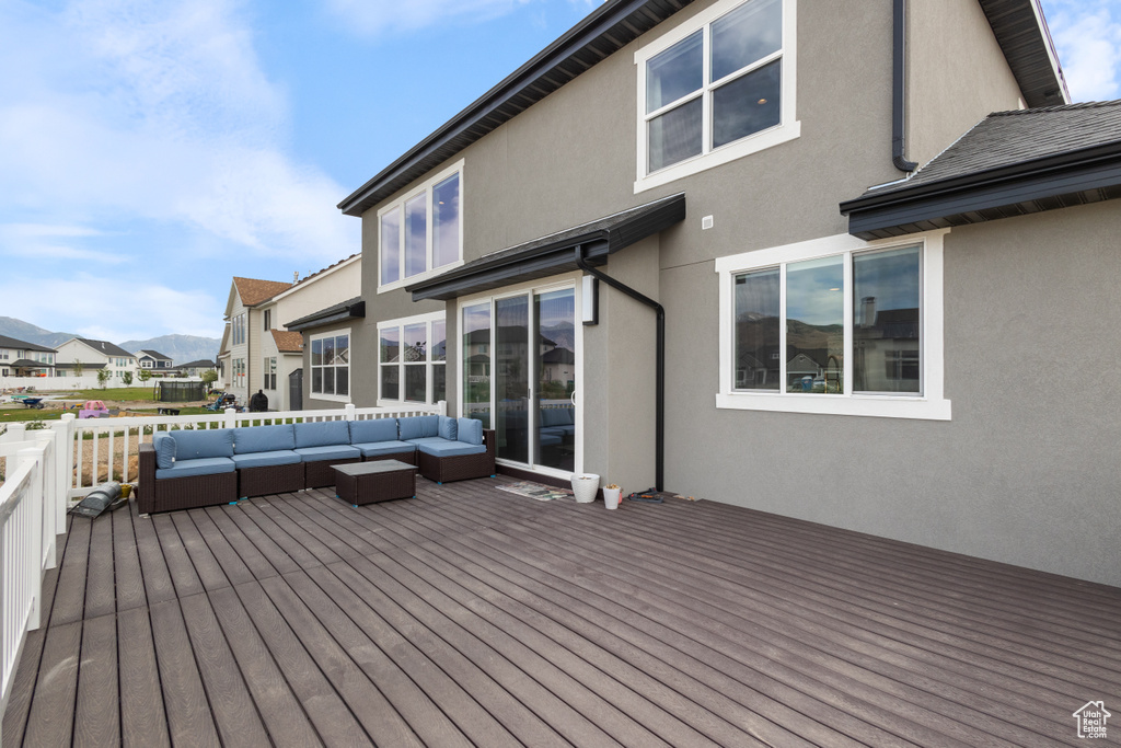 Wooden deck with an outdoor living space and a residential view