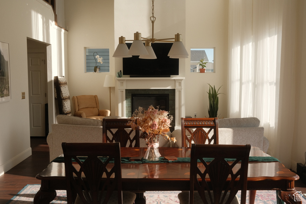 Dining area with wood finished floors and a glass covered fireplace