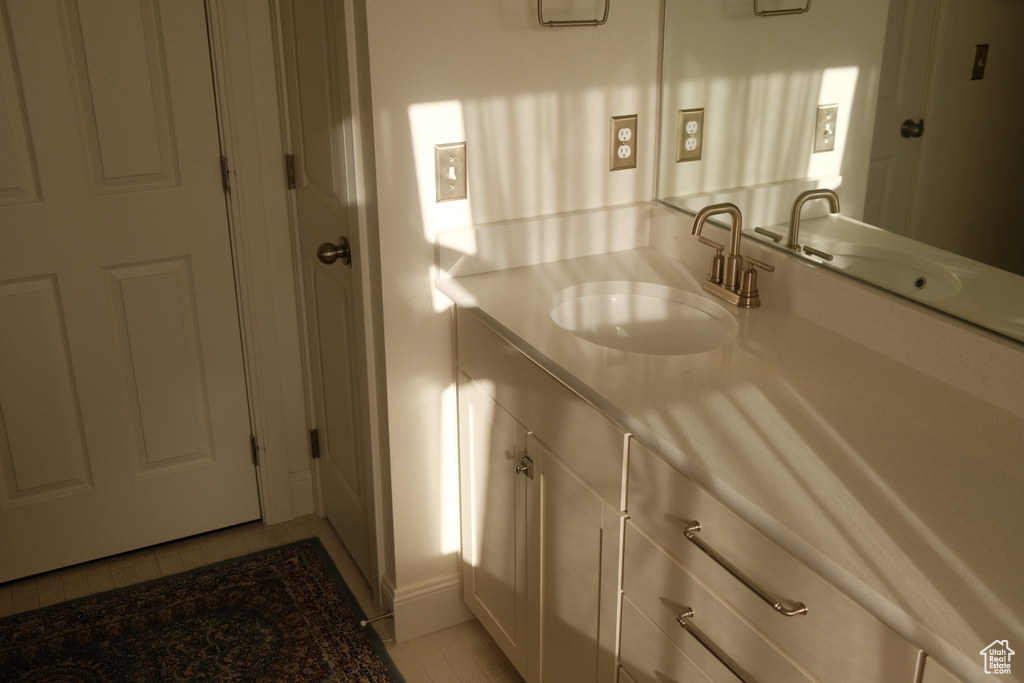 Bathroom featuring vanity and tile patterned flooring