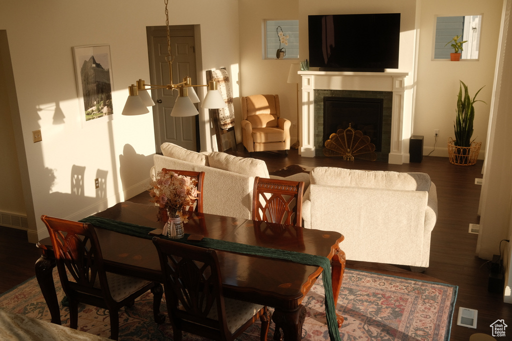 Living area with wood finished floors and a tiled fireplace