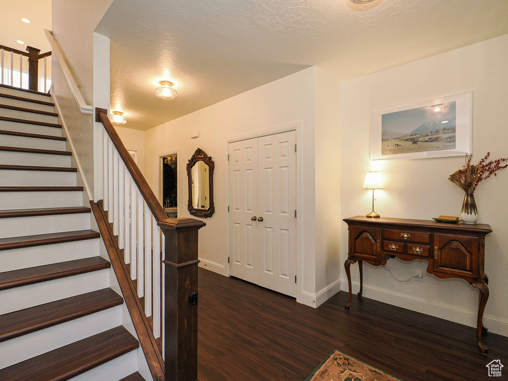 Staircase featuring wood finished floors and baseboards