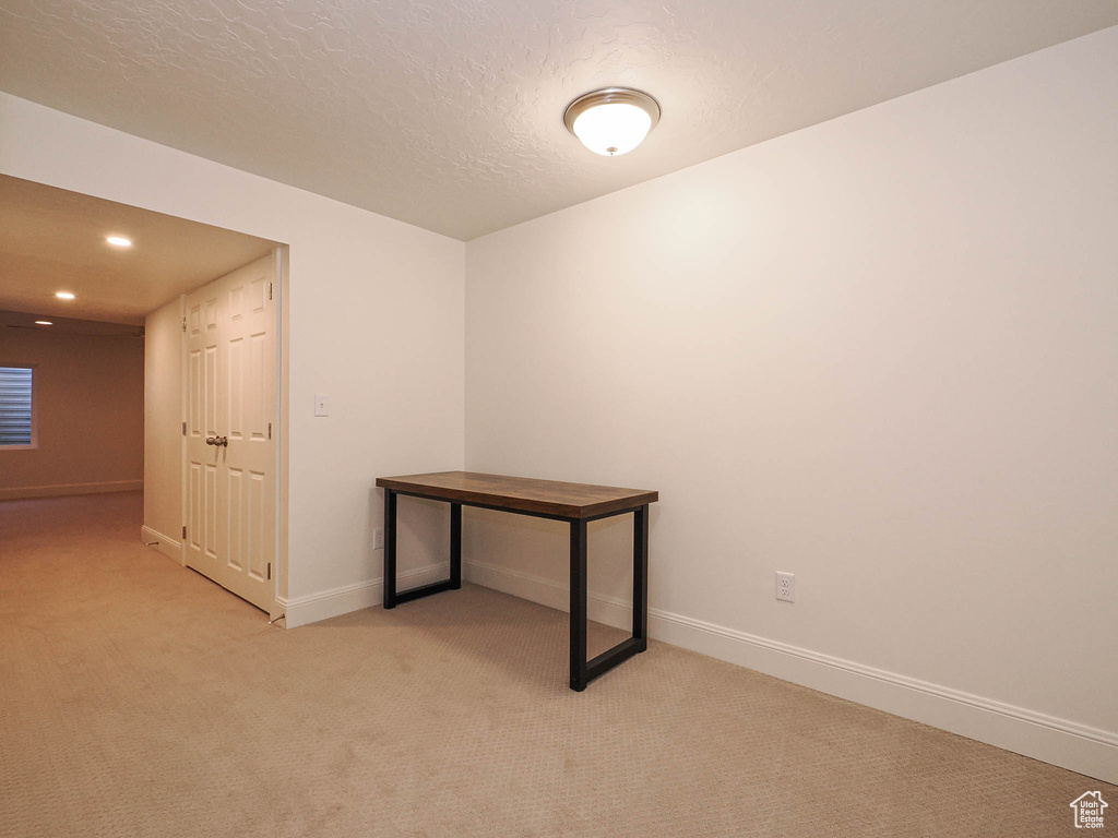 Unfurnished room featuring light colored carpet, recessed lighting, and a textured ceiling