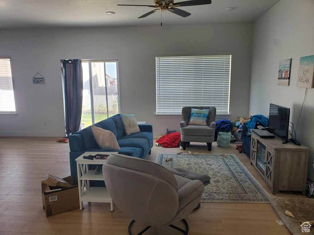 Living area featuring wood finished floors and a ceiling fan