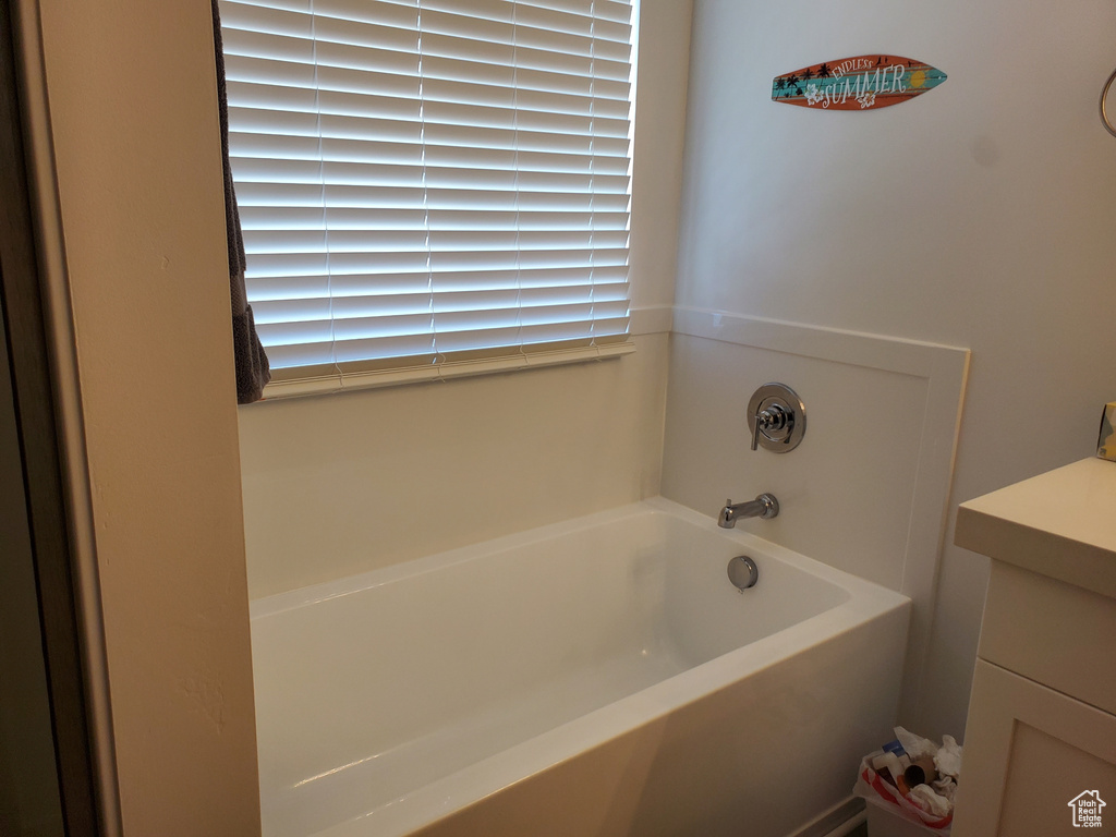 Full bath featuring a garden tub and vanity