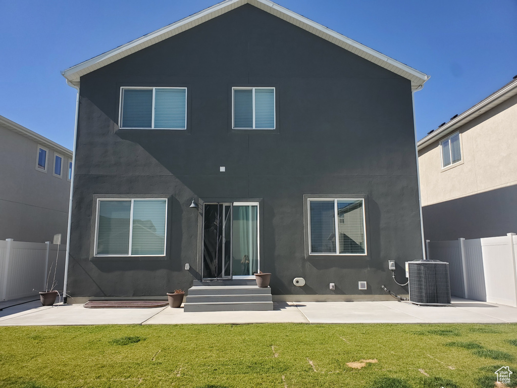 Back of property with a patio and stucco siding