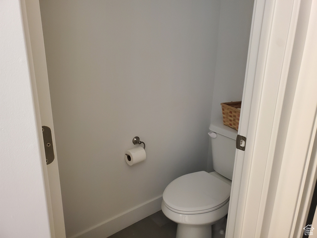 Bathroom with toilet and baseboards