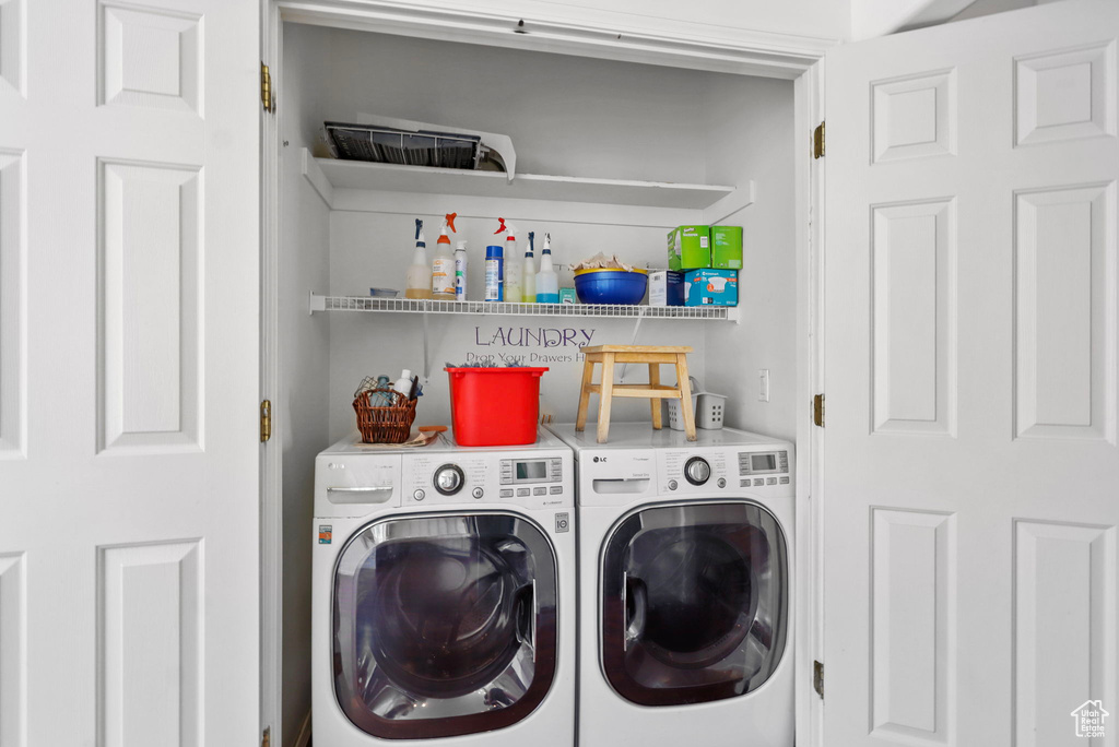 Washroom with washer and clothes dryer