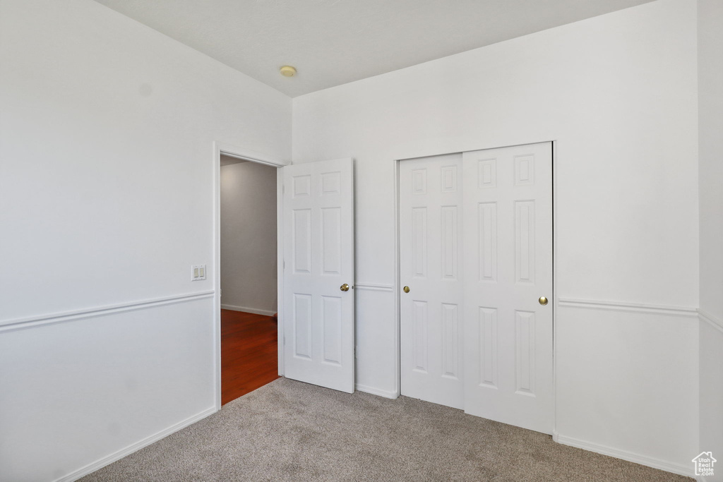 Unfurnished bedroom with carpet floors and a closet