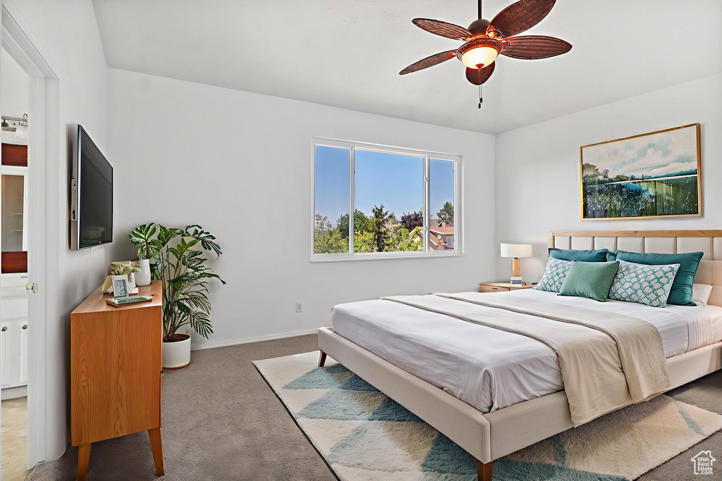 Carpeted bedroom featuring baseboards and a ceiling fan