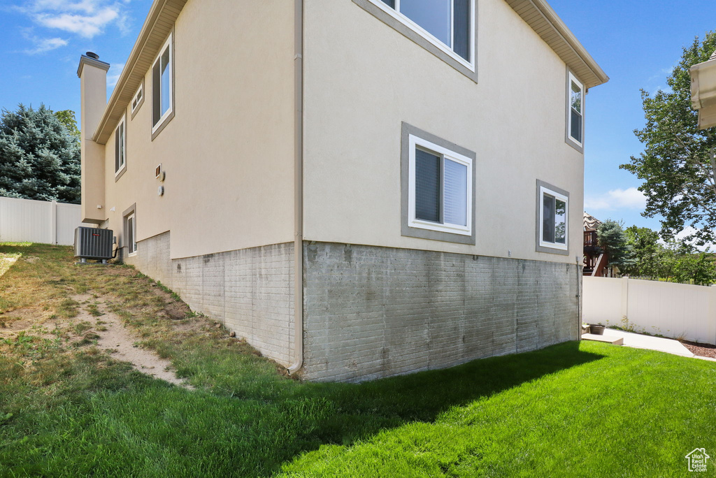 View of property exterior featuring stucco siding and a chimney