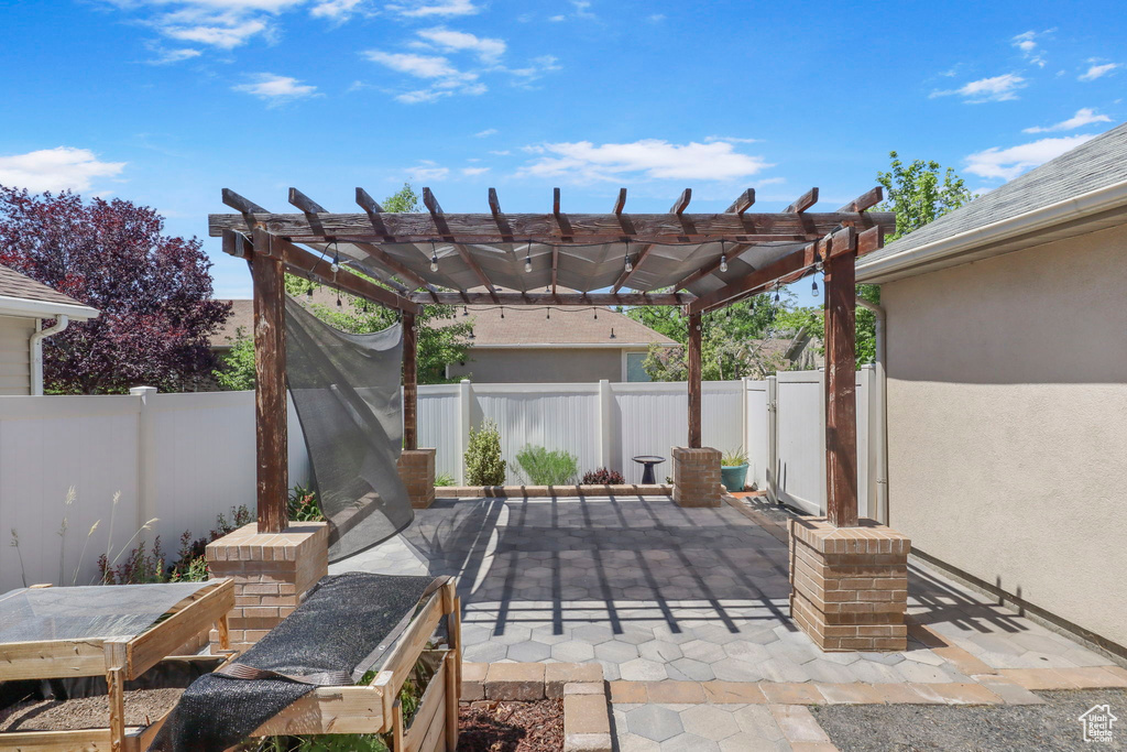 Fenced backyard with a patio area and a pergola