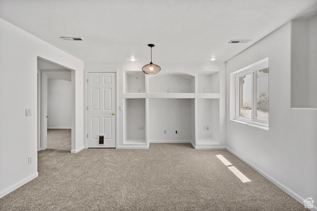 Carpeted empty room with baseboards