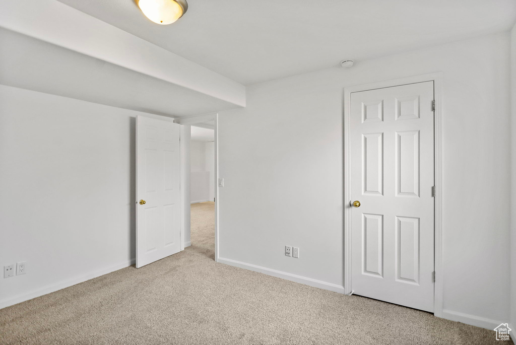 Unfurnished bedroom featuring carpet floors and baseboards