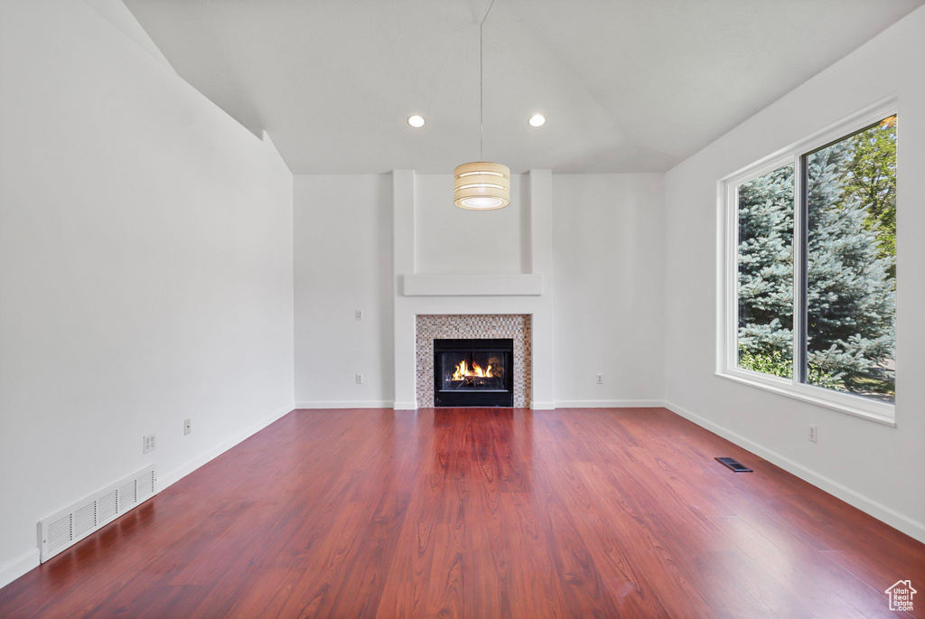 Unfurnished living room with a tile fireplace, wood finished floors, and recessed lighting
