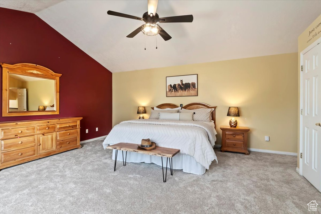 Bedroom featuring vaulted ceiling, carpet floors, and a ceiling fan